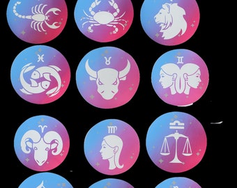 May include: Twelve iron-on patches featuring the astrological zodiac signs. Each patch is a circle with a pink and blue gradient background and a white silhouette of the zodiac symbol. The signs are: Scorpio, Cancer, Leo, Pisces, Taurus, Gemini, Aries, Virgo, Libra, Sagittarius, Aquarius, and Capricorn.