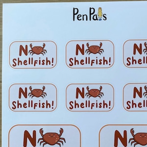 May include: Eight rectangular stickers with a white background and a brown border. Each sticker features a cartoon crab with a sad expression and the text "No Shellfish!" in brown letters.
