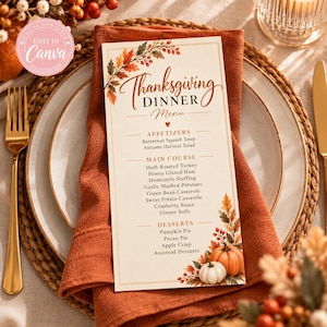 May include: A rectangular Thanksgiving dinner menu card featuring autumn leaf illustrations, orange pumpkin graphics, and text listing appetizers, main courses, and desserts. The menu is printed on cream paper with a gold border and brown typography.