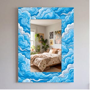 May include: A rectangular wall mirror featuring a wide, decorative frame adorned with a vibrant, repeating illustration of stylized blue and white clouds. The reflective glass surface displays a bedroom interior with a bed, plants, and wall art.