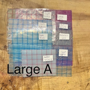 May include: A set of clear plastic sheets with grid lines, labeled with different sizes and names like "Gem", "Corfetti", "Fem", "Ambros fl", "Reedal", and "Large A".