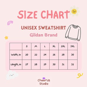 May include: A pink size chart for a unisex Gildan brand sweatshirt. The chart shows measurements in inches for sizes S to 3XL. Width measurements range from 50.8 to 76.2 cm, and length measurements range from 68.6 to 81.3 cm.