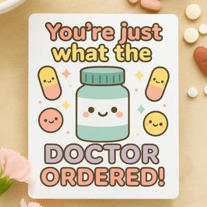 May include: A white card with the text "You're just what the DOCTOR ORDERED!" in a playful font. The card features a cartoon pill bottle and pills in pastel colours, with smiling faces.
