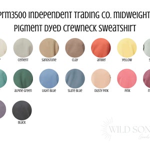 May include: A color chart for a pigment-dyed crewneck sweatshirt, featuring a range of colors including ivory, cement, sandstone, clay, amber, yellow, sage, mint, alpine green, light blue, slate blue, dusty pink, pink, maroon, plum, and black. The text "Prm3500 INDEPENDENT TRADING CO. MIDWEIGHT PIGMENT DYED CREWNECK SWEATSHIRT" is at the top.