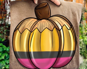May include: A brown t-shirt featuring a cartoon pumpkin design. The pumpkin is divided into sections of gold, black, and pink, with a brown stem. The design is a playful take on a fall theme.