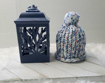 Blue, orange, and white handmade knit baby hat with matching handmade pom