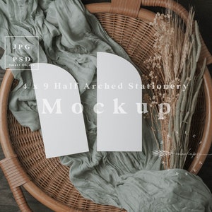 May include: A styled mockup with two 4 x 9 inch half-arched stationery cards. The white cards are arranged on a wicker basket with sage green fabric and dried flowers. The image includes the word "Mockup".