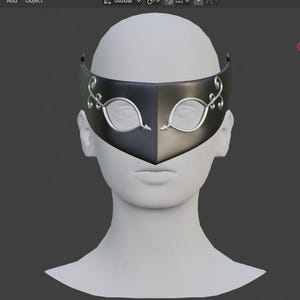 May include: A black and silver masquerade mask with a symmetrical design. The mask features a split color scheme, with a black left side and a silver right side. Silver leaf-shaped eye details and decorative flourishes adorn the mask.