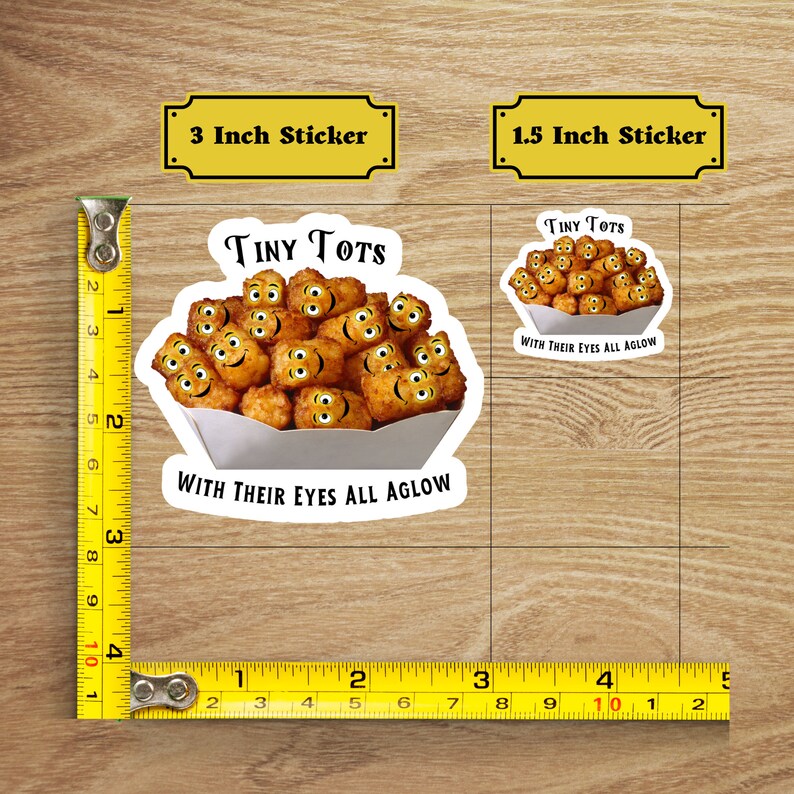 May include: Two sticker options for a funny food-themed design. The larger sticker is 3 inches and shows a white paper container filled with tater tots with smiling faces. The text reads "Tiny Tots with their eyes all aglow". The smaller sticker is 1.5 inches and shows a smaller version of the same design.