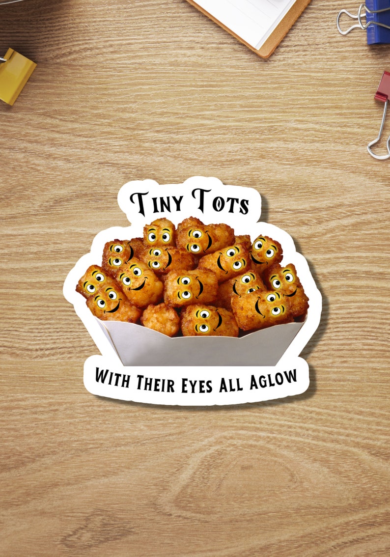 May include: A white paper container filled with tiny tots, or potato tots, with smiling faces. The container has the text "Tiny Tots" above the tots and "With Their Eyes All Aglow" below the tots.