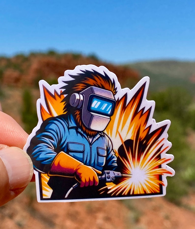 May include: A cartoon illustration of a welder wearing a blue jumpsuit and a welding mask. The welder is holding a welding torch and sparks are flying from the torch. The background is a yellow and orange burst of light.
