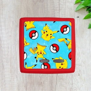 May include: Red case with a blue background featuring a repeating pattern of yellow Pikachu characters and red and white Poke Balls.