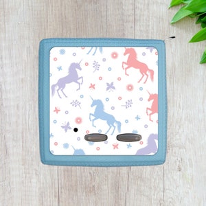 May include: A light blue zippered pouch with a white background featuring a repeating pattern of pink and purple unicorns, flowers, and butterflies.