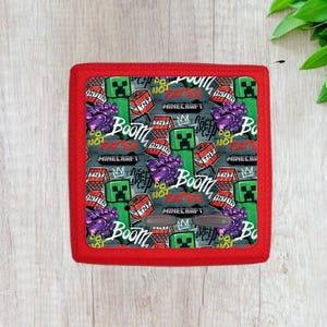 May include: Red speaker with a Minecraft themed design. The design features green creeper characters, TNT blocks, and the words "Boom", "Do Not Enter", and "Minecraft".