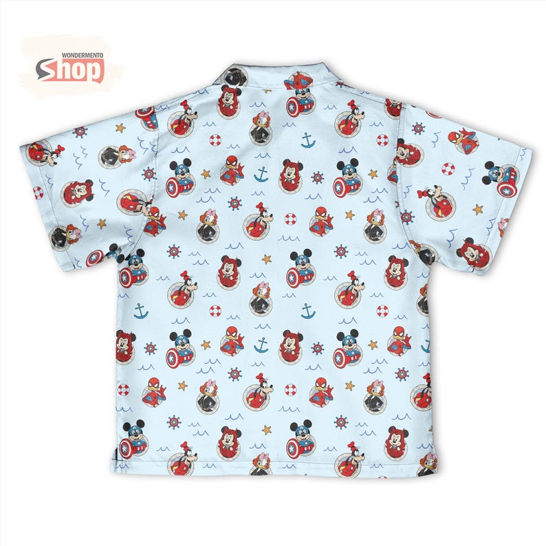 May include: A light blue short-sleeve button-down shirt featuring an all-over print of various cartoon characters, including Mickey Mouse, Goofy, and Spider-Man, interspersed with nautical symbols like anchors, life preservers, and ship wheels.