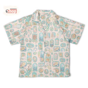 May include: A short-sleeved button-up shirt with a light pink background and a repeating pattern of cartoon dogs in various settings. The shirt has a collared neckline and the text "WONDERMENTO Shop" is visible.