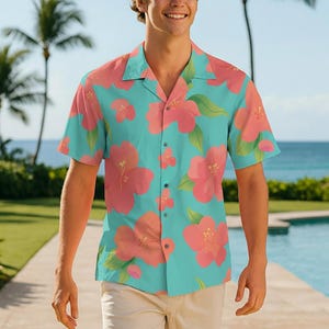 May include: A short-sleeved button-down shirt with a turquoise background and large coral-colored floral patterns. The shirt has a classic collar and is made of a lightweight fabric, perfect for warm weather. The shirt is part of a tropical-themed clothing collection.
