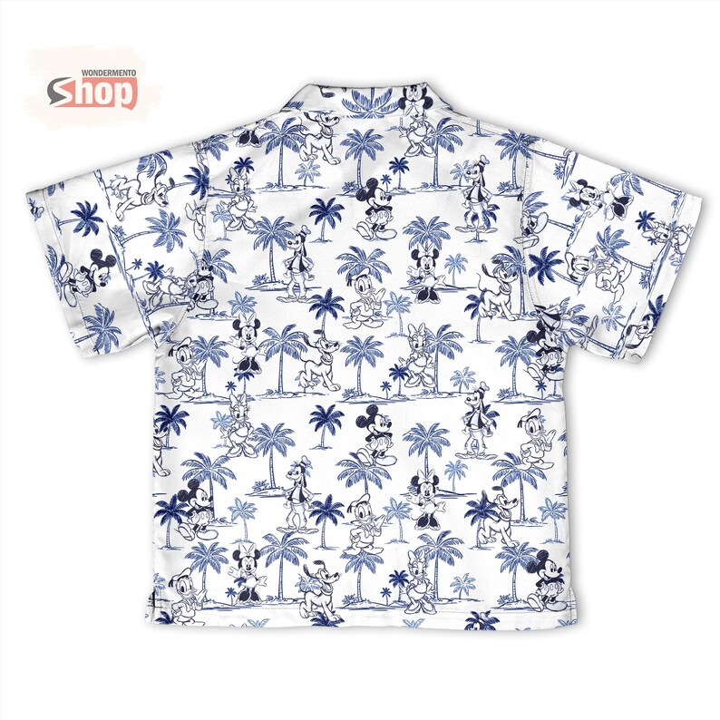 May include: A short-sleeved button-down shirt in white featuring an all-over blue print of Disney characters including Mickey Mouse, Minnie Mouse, Donald Duck, Daisy Duck, Goofy, and Pluto interspersed with palm trees. The shirt has a collar.