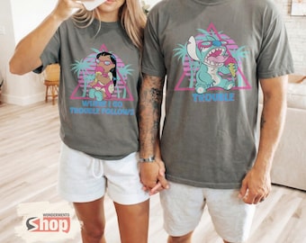 May include: Two grey t-shirts with matching graphics. One shirt features Lilo with the text "WHERE I GO, TROUBLE FOLLOWS." The other shirt has Stitch with the text "TROUBLE." Both designs are set against a pink and teal tropical background.