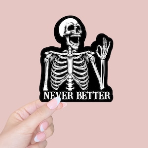 May include: Black and white sticker of a skeleton with a ribcage and a skull giving a thumbs up. The text "NEVER BETTER" is below the skeleton.