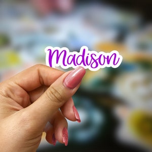 May include: A white sticker with the name "Madison" written in purple cursive lettering.