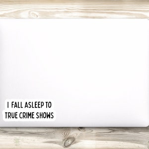 May include: White laptop with a sticker that says "I fall asleep to true crime shows".