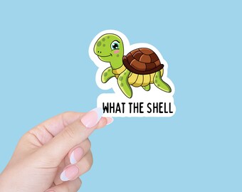 May include: A sticker featuring a cartoon sea turtle with the text "WHAT THE SHELL" in black.