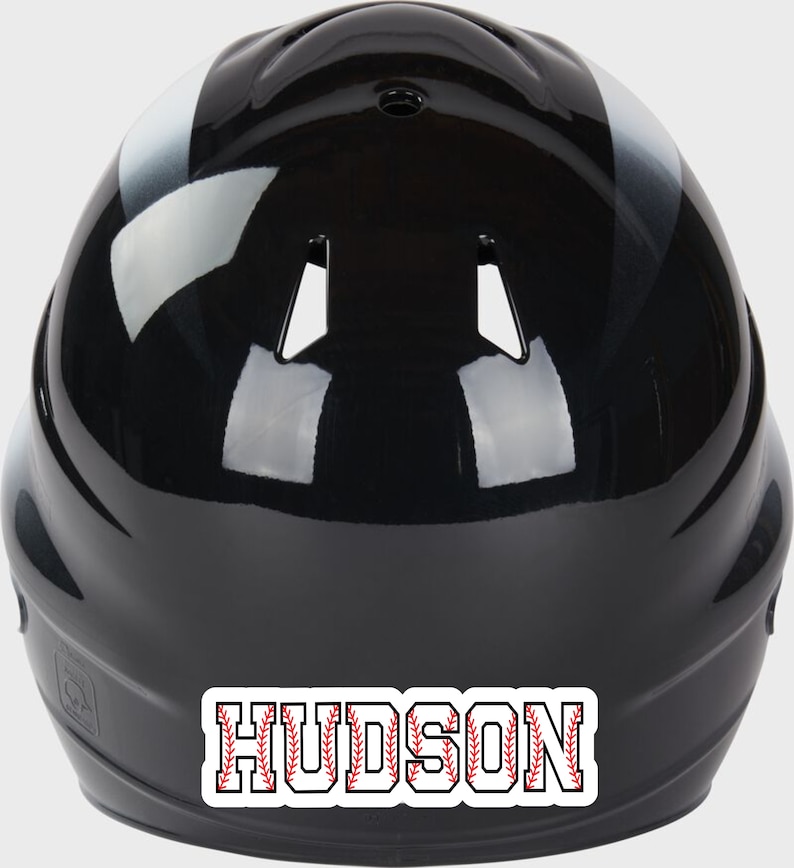 May include: Black baseball helmet with a white stripe and a red and white baseball stitch design nameplate that says "HUDSON".
