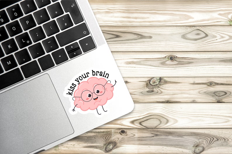 May include: A pink brain cartoon character wearing glasses with the text "kiss your brain" on a white sticker.