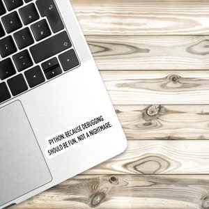 May include: A silver laptop computer with a black keyboard and a white sticker on the back that says "PYTHON: BECAUSE DEBUGGING SHOULD BE FUN, NOT A NIGHTMARE."