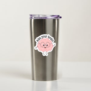 May include: A stainless steel travel mug with a pink brain sticker that says "Kiss your brain".