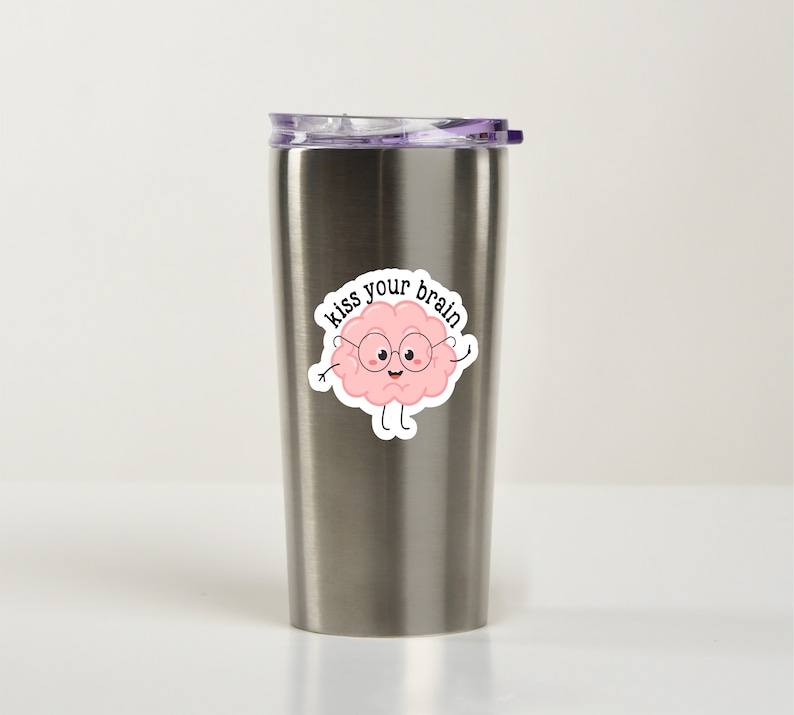 May include: A stainless steel travel mug with a pink brain sticker that says "Kiss your brain".