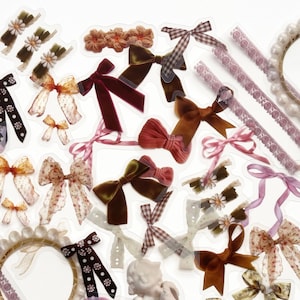 May include: A collection of decorative stickers featuring bows, ribbons, and angels. The stickers are on a white background and are perfect for adding a touch of whimsy to any project.