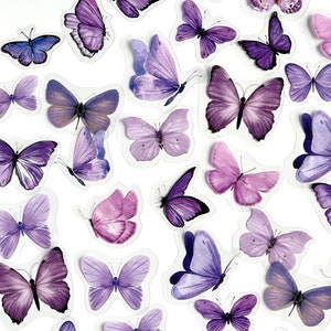 May include: A collection of purple butterfly stickers. The butterflies are arranged in a circular pattern on a white background.