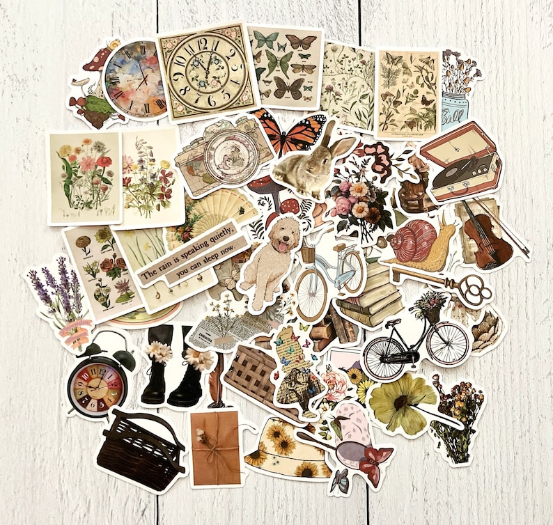 May include: A collection of vintage-style stickers featuring various designs, including flowers, animals, clocks, bicycles, and a quote about the rain. The stickers are printed on white paper and have a matte finish.