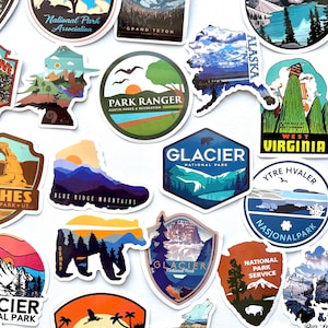 May include: A collection of colorful stickers featuring national parks and scenic landscapes. The stickers feature various designs, including mountains, trees, and animals. The text on the stickers includes "National Park Association", "Grand Teton", "Park Ranger", "Glacier National Park", "West Virginia", "Ytre Hvaler Nasjonalpark", "National Park Service", and "Blue Ridge Mountains".