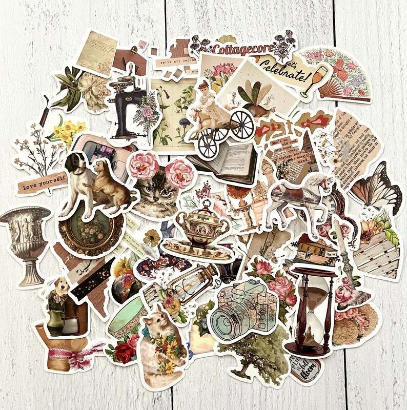 May include: A collection of vintage-style stickers featuring various images, including animals, flowers, teacups, a camera, an hourglass, and a sewing machine. The stickers are printed on white paper with a matte finish and have a distressed, vintage look. The text "Cottagecore" and "Celebrate!" is visible on some of the stickers.