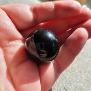 Small silver sheen obsidian sphere