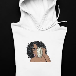 girl holding stack of cash to her ear hoodie