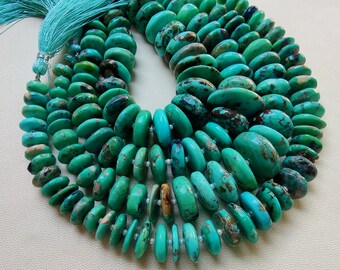 May include: A necklace composed of turquoise-colored, oval-shaped beads. The beads vary in size and are strung together, creating multiple strands. A turquoise tassel hangs from the top. The beads have brown and black inclusions.