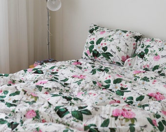 Set of three linens. Duvet cover and two pillowcases for the bedroom. Printed floral and leaf motif in green.