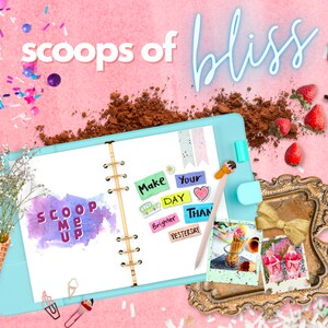 May include: A blue planner with the words "Scoop Me Up" written in pink and purple. The planner has a gold spiral binding and is decorated with colorful stickers that say "Make Your Day Brighter Than Yesterday".