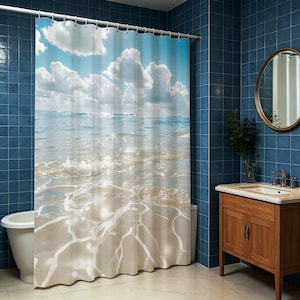 May include: A shower curtain featuring a beach scene with a blue sky, white clouds, and ocean waves. The curtain's design evokes a sense of tranquility and is suitable for a bathroom with a coastal theme.