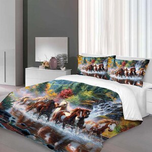 May include: A white duvet cover with a colorful painting of horses running through a forest and waterfall. The duvet cover features a vibrant autumnal scene with red, yellow, and green leaves.