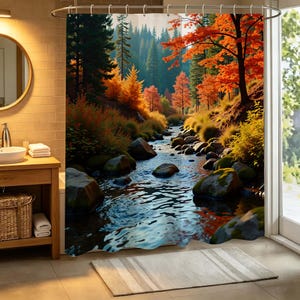 May include: A shower curtain featuring a printed landscape of a flowing stream winding through a forest during autumn. The scene displays mossy rocks in the water, vibrant orange and yellow foliage on the trees, and tall evergreen pines.