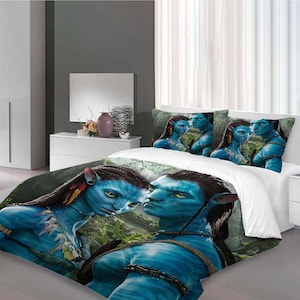 May include: A white duvet cover featuring a blue and green jungle scene with two blue-skinned characters from the film Avatar. The duvet cover comes with two matching pillowcases with the same characters.