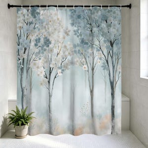 May include: A shower curtain featuring a watercolor forest scene. The design includes trees with white and blue blossoms against a soft, misty background. The curtain is hung on a black rod in a bathroom setting.