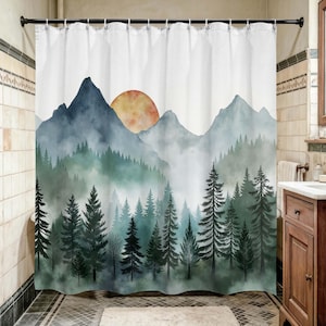 May include: A white shower curtain with a watercolour landscape design. The image depicts blue mountains, green trees, and a setting sun in orange. The overall effect is hazy and atmospheric, creating a serene forest scene.