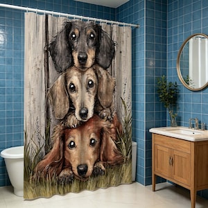 May include: A shower curtain featuring a vertical stack of three long-haired dachshund dogs with large eyes. The dogs are positioned against a background of light-colored vertical wooden planks and green grass, with a white rod and rings at the top.