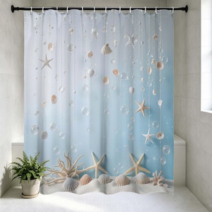 May include: A blue and white shower curtain with a beach theme. The curtain features seashells, starfish, and bubbles suspended on strings. The bottom of the curtain has a sandy beach design with seashells and starfish. A potted fern is on the left.